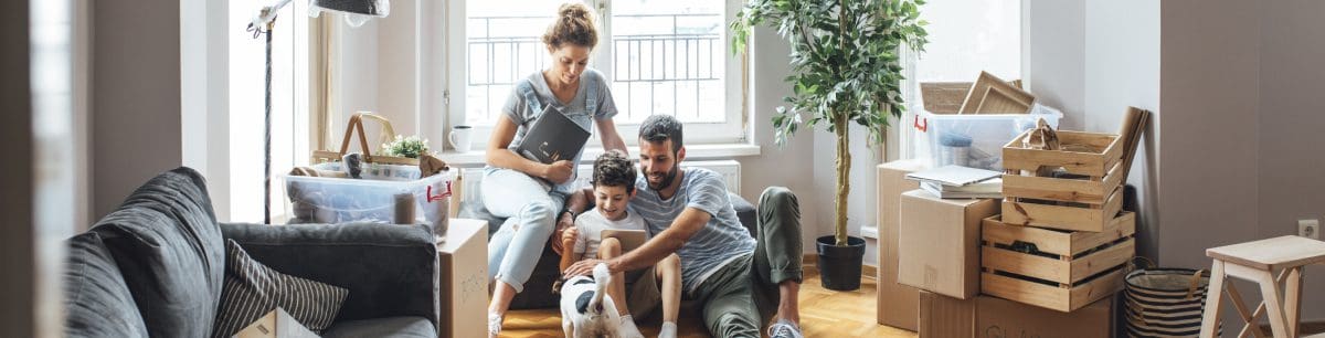 A family grouped on a sofa looking happy with their living wage