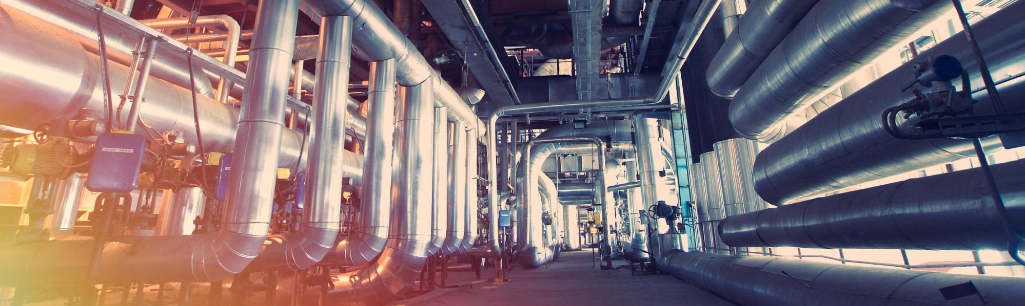 A picture of shiny internal pipes inside a factory