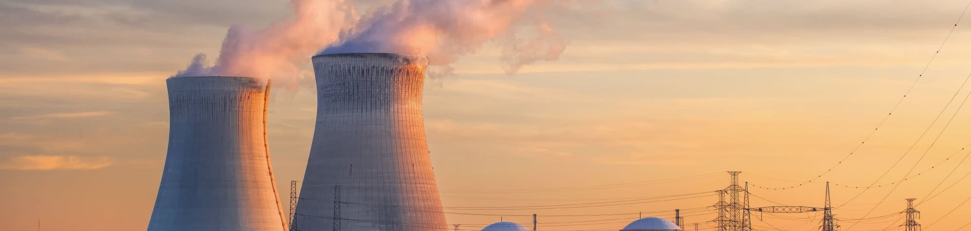 Nuclear cooling towers against a sunset background