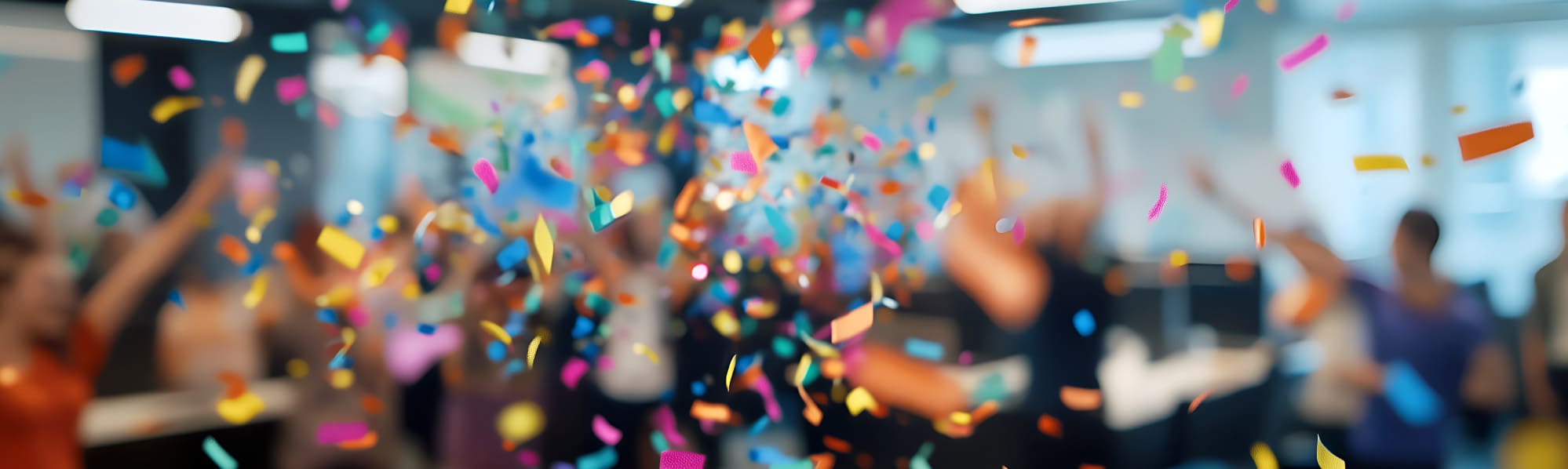 Colourful confetti falling in a business room - blurred background